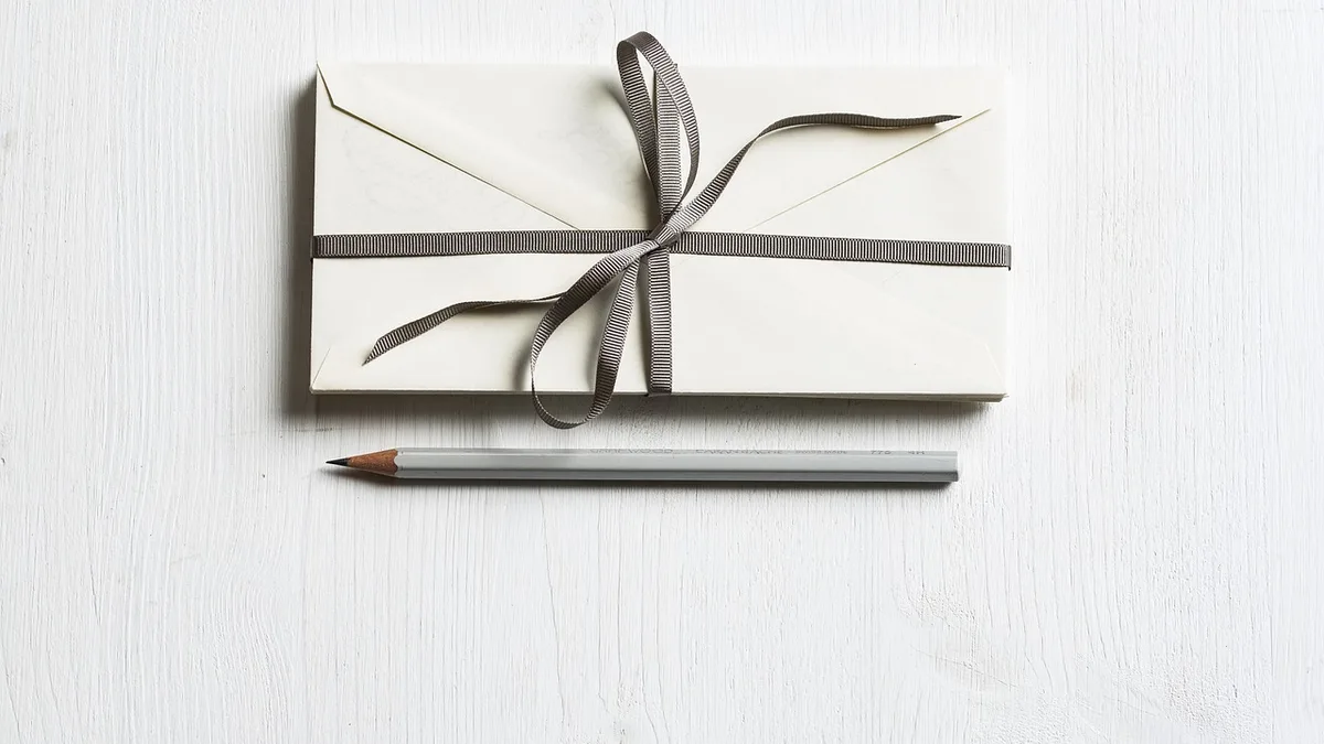 A gift envelope with a decorative card representing an entertainment voucher for a Dubai event