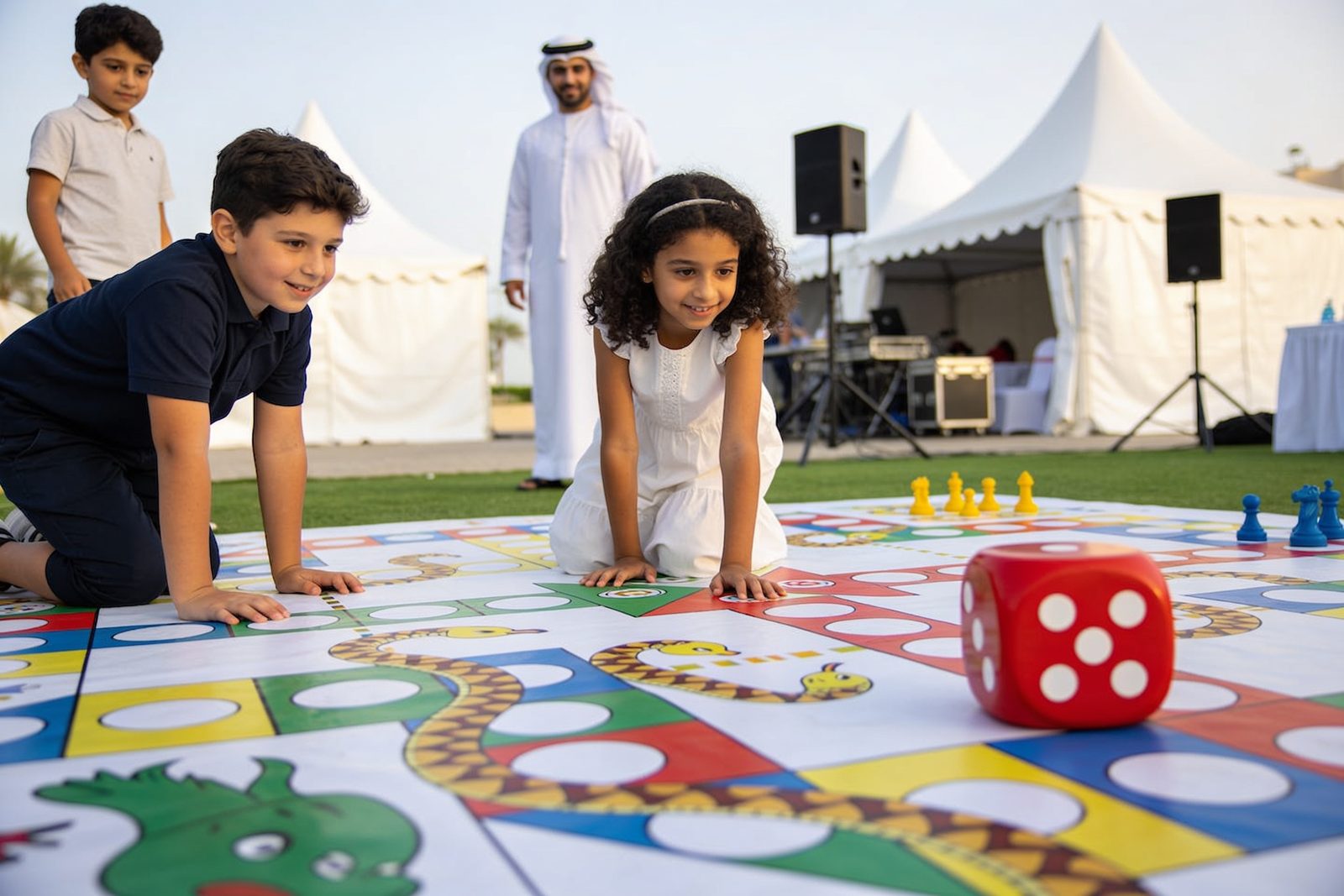 Children playing giant snakes and ladders at a Dubai party