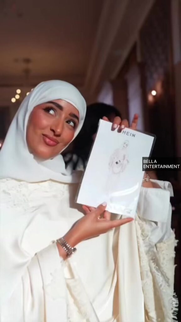 Guest holding her live illustration at an event in Dubai Guest holding her live illustration at an event in Dubai